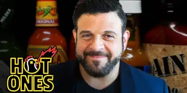 Adam Richman Impersonates Noel Gallagher While Eating Spicy Wings